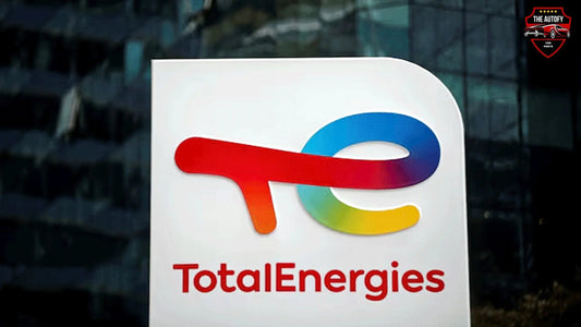 TotalEnergies colorful logo on sign with THEAUTOFY.COM car parts shield in corner